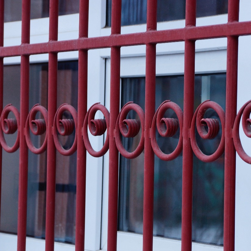 Metal texture of red forged rods with a pattern on the window jpg